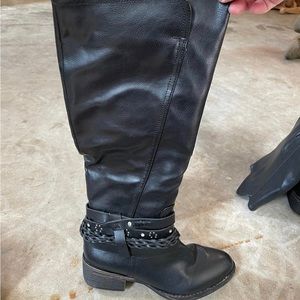 Black high boots with wraps made into the ankle part of the boots